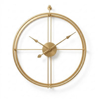 Horloge murale dorée design au style épuré, mise en valeur sur un fond blanc neutre et lumineux. Son cadran minimaliste à double cercles et son aiguille ornée d'une feuille apportent une note raffinée à votre décoration.