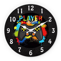 l'horloge murale gaming ronde "Player The Best" avec manette de jeu vidée fond noire et éclaboussures de peinture multicolores