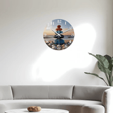 salon-Horloge murale zen représentant cinq pierres naturelles empilées les unes sur les autres dans un équilibre parfait. Ce design inspiré des pierres zen évoque la sérénité, l’harmonie et la connexion avec la nature. Les différentes couleurs des pierres créent une composition douce et apaisante rappelant un paysage de plage calme avec une vue sur la mer. Cette horloge décorative apporte une ambiance relaxante dans un salon, une chambre ou un espace de méditation. Ses chiffres blancs et ses aiguilles éléga