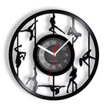 Horloge murale disque vinyle ajourée avec multiples figures pole dance silhouettes.