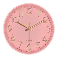 Horloge murale rose nordique scandinave de 30 cm de diamètre avec chiffres et aiguilles dorés.