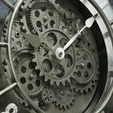 Gros plan détaillé sur le mécanisme central à engrenages apparents et les aiguilles d'une horloge murale de style industriel