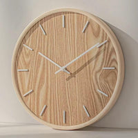 Horloge murale ronde en bois naturel foncé, style scandinave et minimaliste, idéale pour une décoration de salon chaleureuse et épurée.
